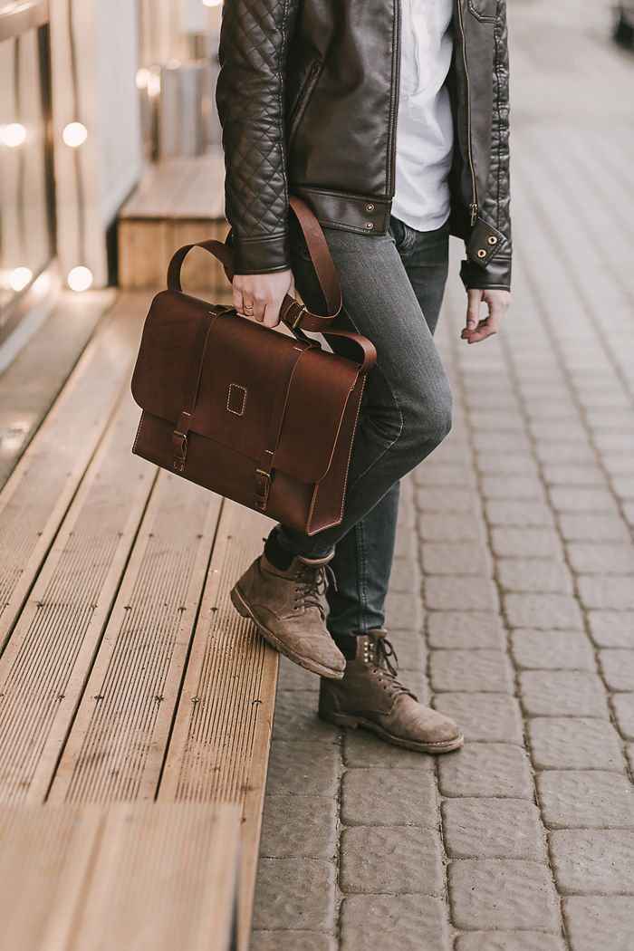 Chic urban style with a premium leather briefcase carried by a fashionable person standing on a city street.